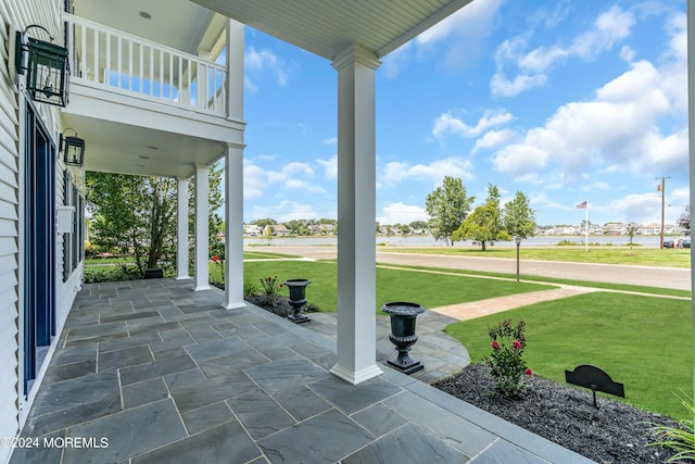 view of patio featuring a porch and a balcony