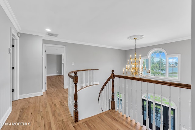 interior space featuring wood-type flooring, a notable chandelier, and crown molding