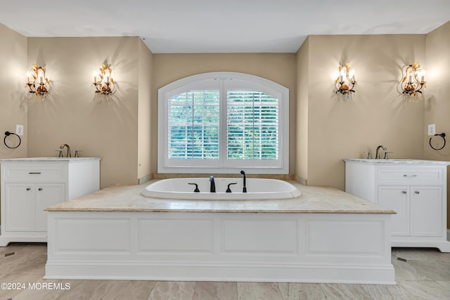 bathroom with vanity and a tub