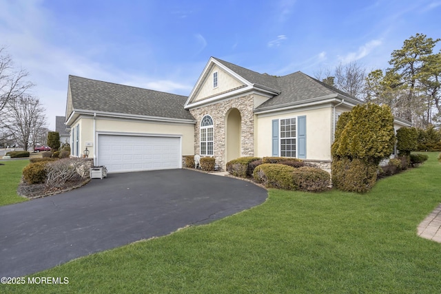 view of front of property featuring a garage, stone siding, aphalt driveway, and a front lawn