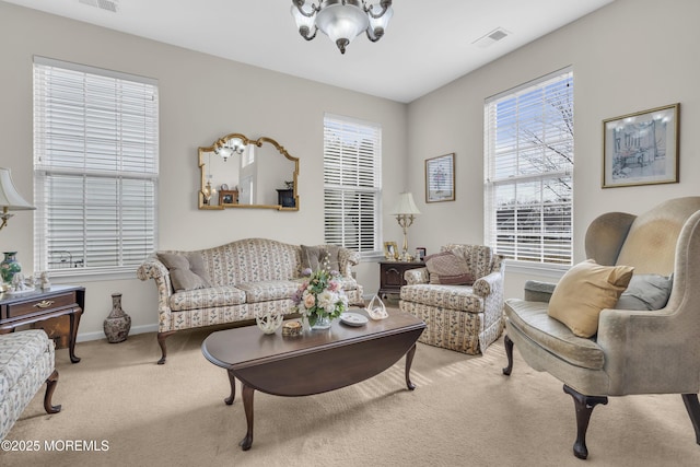 living room with carpet flooring, visible vents, and baseboards