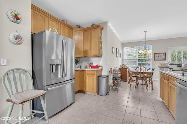 kitchen with ornamental molding, stainless steel appliances, light countertops, and a chandelier