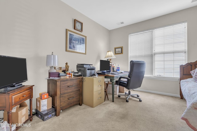 office area featuring light colored carpet, visible vents, and baseboards