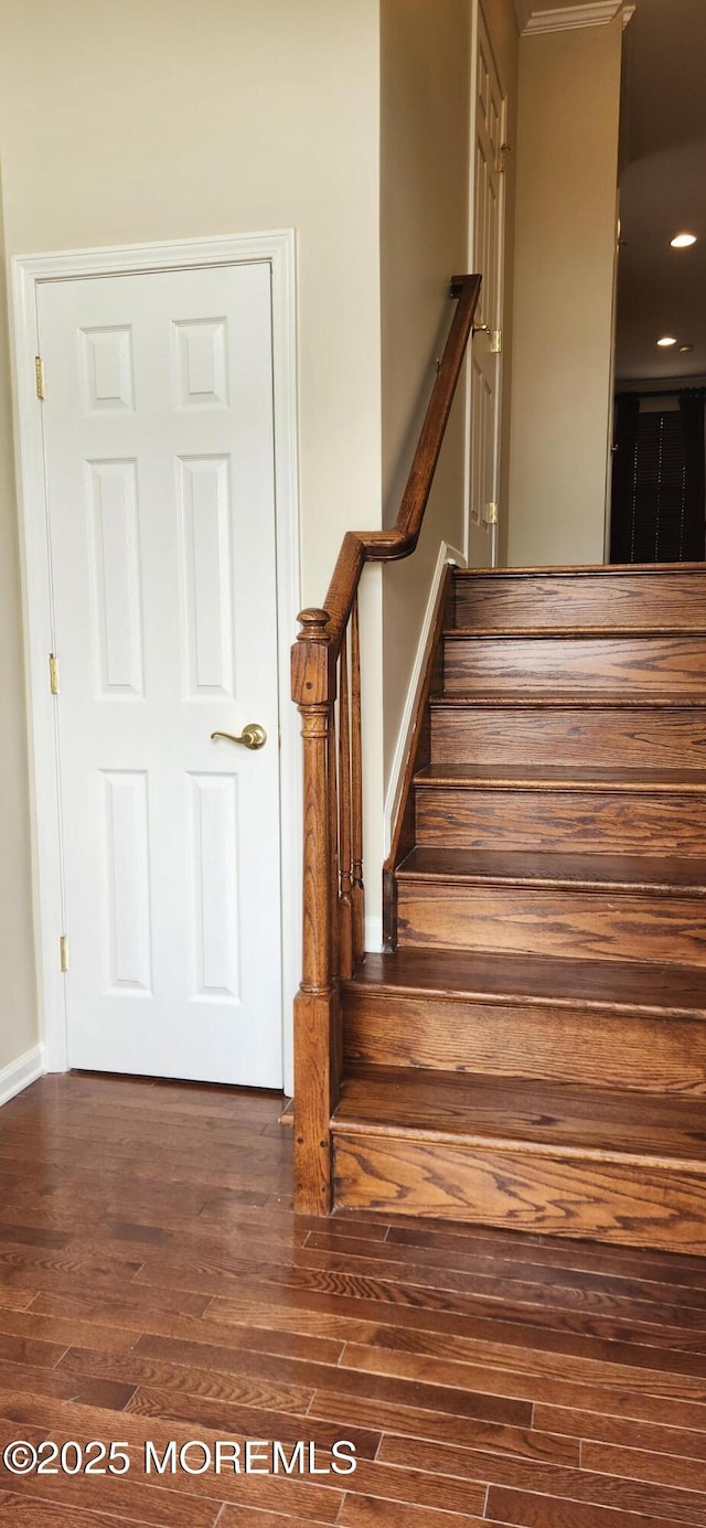 stairs featuring hardwood / wood-style flooring