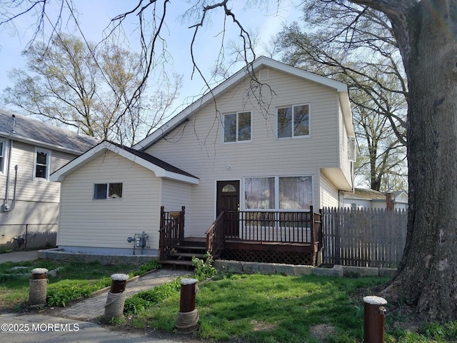 view of front of property featuring a wooden deck and a front lawn