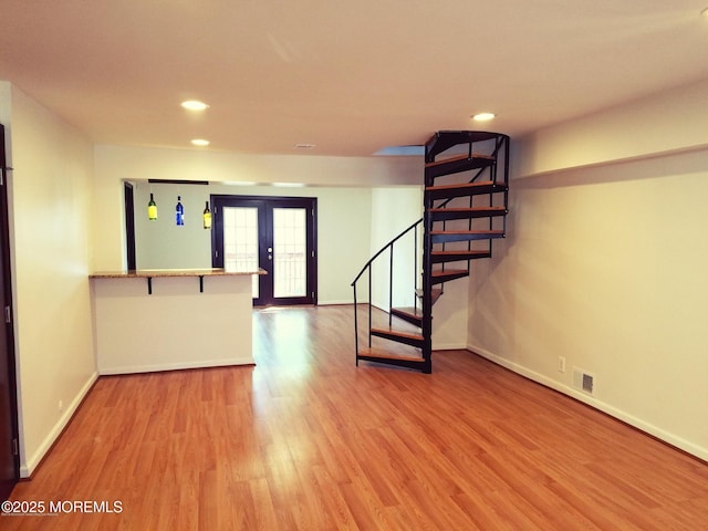 unfurnished room with french doors and hardwood / wood-style flooring