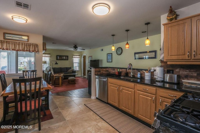 kitchen featuring dishwasher, sink, hanging light fixtures, and a wealth of natural light