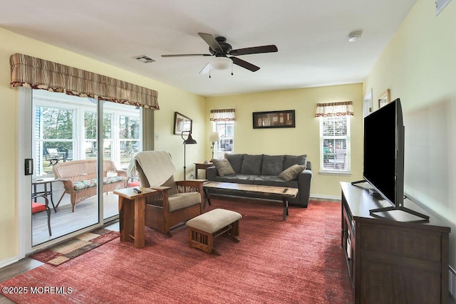 living room with dark carpet and ceiling fan