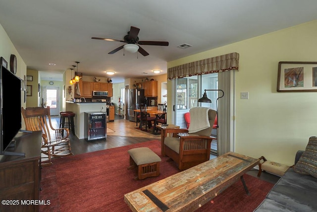 living room featuring dark hardwood / wood-style flooring and ceiling fan