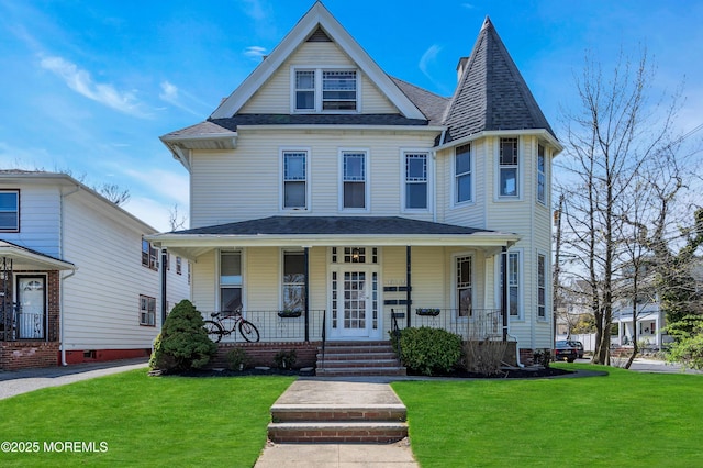 victorian house with a porch and a front lawn