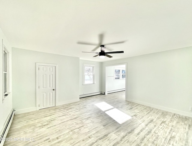 spare room with baseboard heating, ceiling fan, and light hardwood / wood-style floors