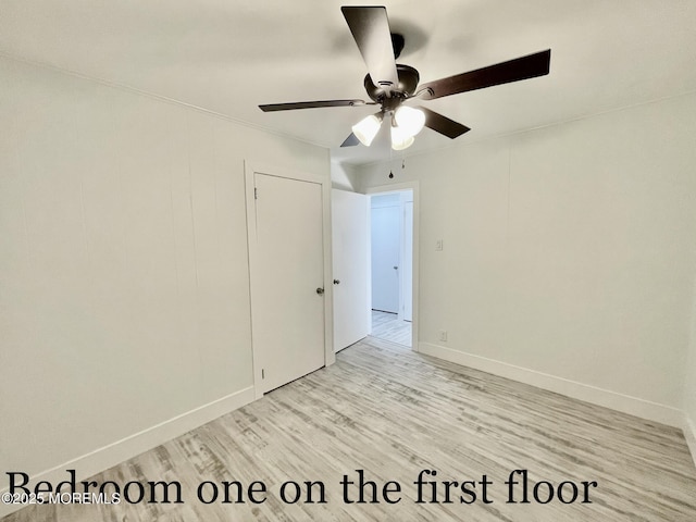 empty room with ceiling fan and light wood-type flooring