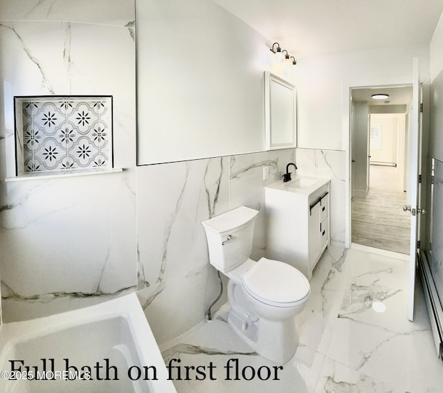 bathroom with vanity, toilet, and a washtub