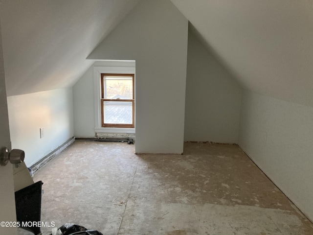 bonus room with a baseboard radiator and lofted ceiling