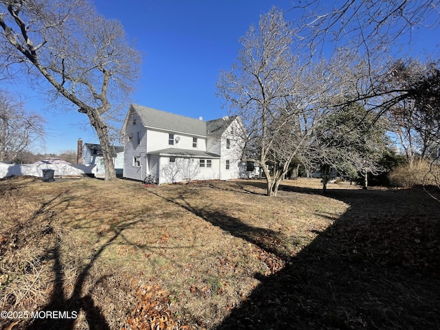 back of house with a yard