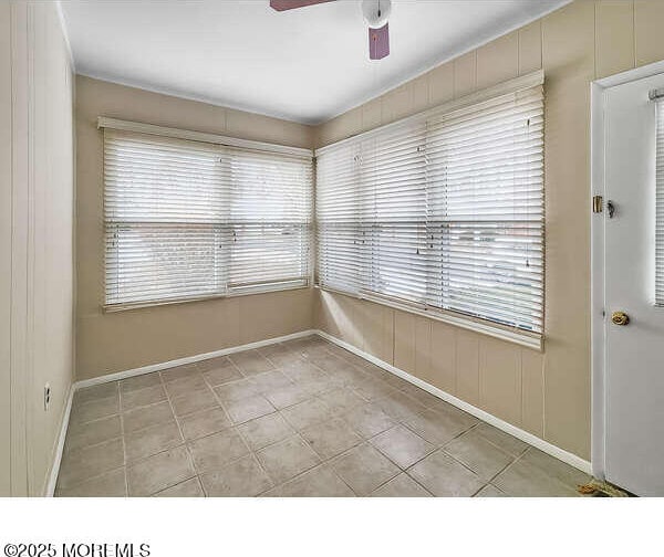 unfurnished room featuring ceiling fan