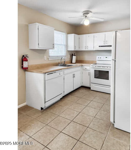 kitchen with sink, white appliances, white cabinets, and ceiling fan