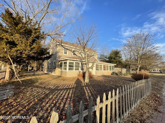 view of property exterior featuring a sunroom