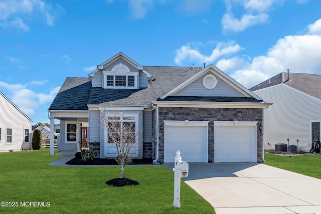 view of front facade featuring a garage, cooling unit, and a front lawn