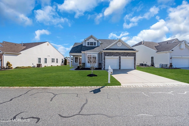 view of front of home featuring a garage, central AC unit, and a front lawn