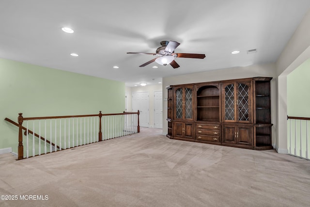 spare room with light carpet and ceiling fan