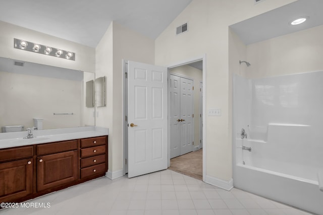 full bathroom featuring shower / washtub combination, toilet, vaulted ceiling, and vanity