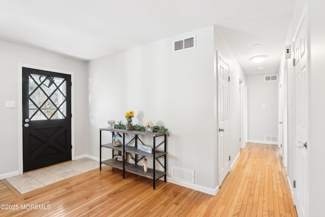 entryway with light hardwood / wood-style floors