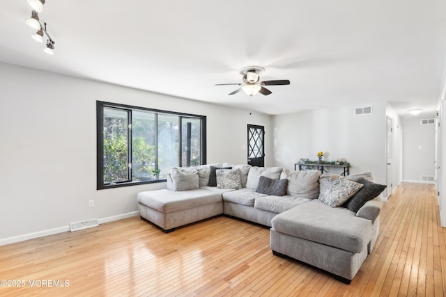 living room with light hardwood / wood-style floors and ceiling fan