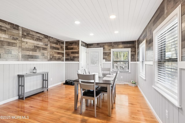 dining area featuring wood-type flooring and wood ceiling