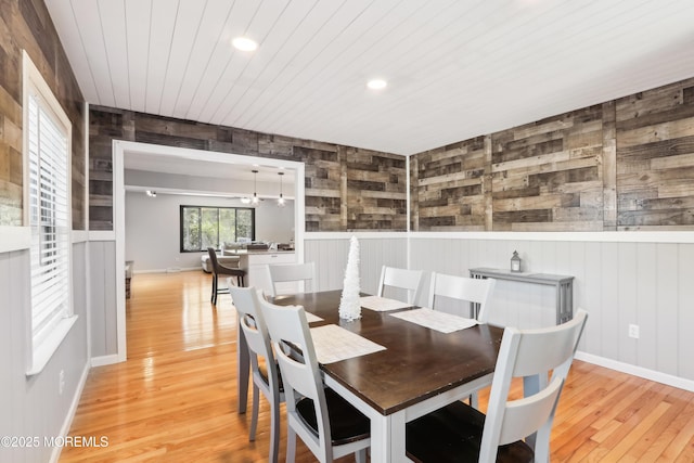 dining room featuring a notable chandelier, wood ceiling, and light hardwood / wood-style flooring