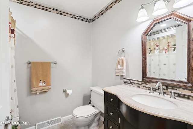 bathroom with tasteful backsplash, vanity, and toilet