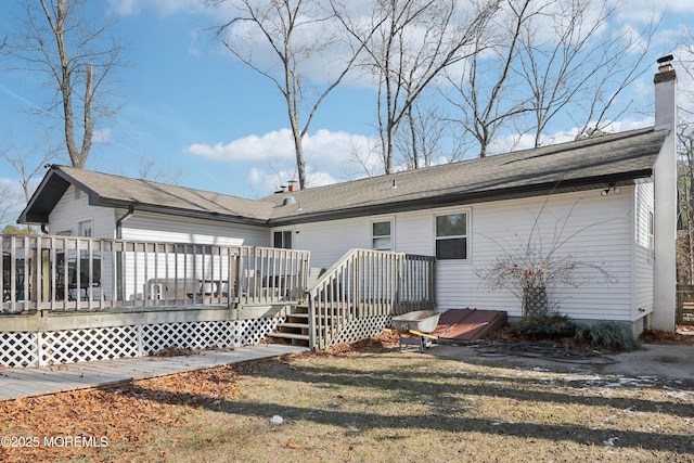 back of property featuring a wooden deck