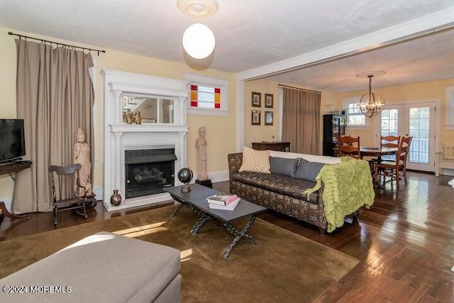 living room featuring dark hardwood / wood-style flooring and a notable chandelier