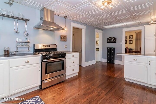 kitchen featuring white cabinets, stainless steel range with gas cooktop, dark hardwood / wood-style floors, and ventilation hood