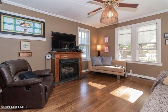 living room with crown molding, hardwood / wood-style floors, and ceiling fan