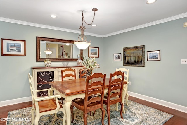 dining room with crown molding and wood-type flooring