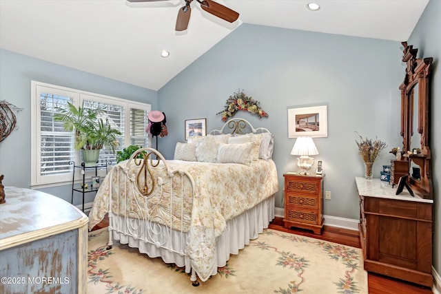 bedroom with hardwood / wood-style flooring, ceiling fan, and lofted ceiling