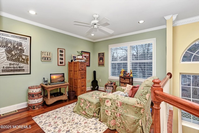 living area featuring crown molding, hardwood / wood-style floors, and ceiling fan