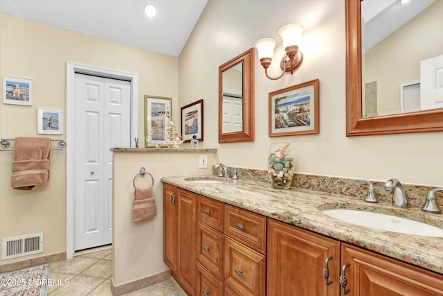 bathroom featuring vanity, tile patterned floors, and lofted ceiling