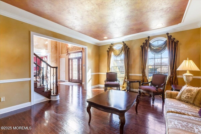 living area with crown molding and hardwood / wood-style floors