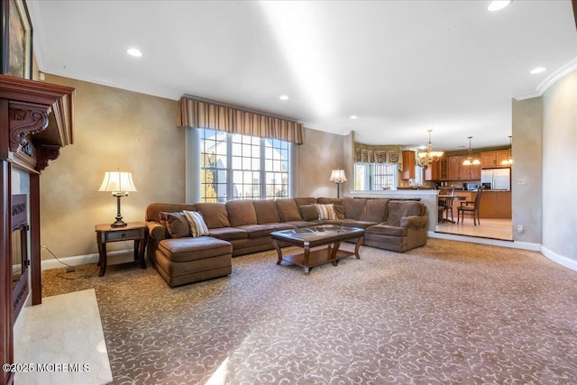 living room featuring an inviting chandelier, carpet floors, and ornamental molding