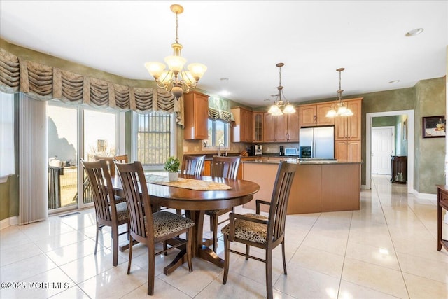 dining room featuring light tile patterned floors and a notable chandelier