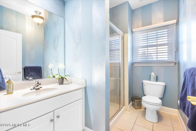 bathroom with vanity, a shower with shower door, tile patterned floors, and toilet