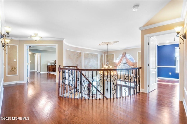 hall featuring an inviting chandelier, crown molding, and dark hardwood / wood-style flooring