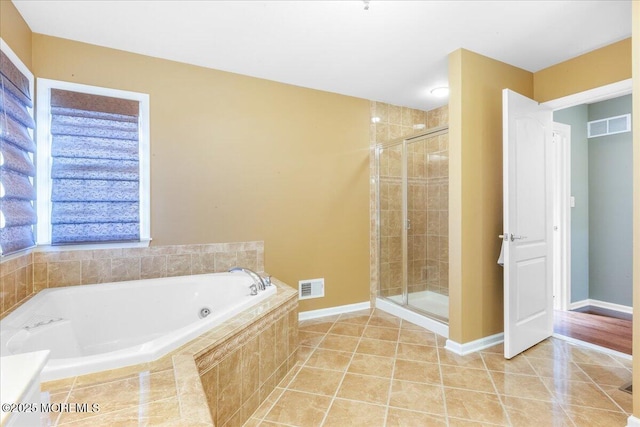 bathroom with tile patterned floors and separate shower and tub