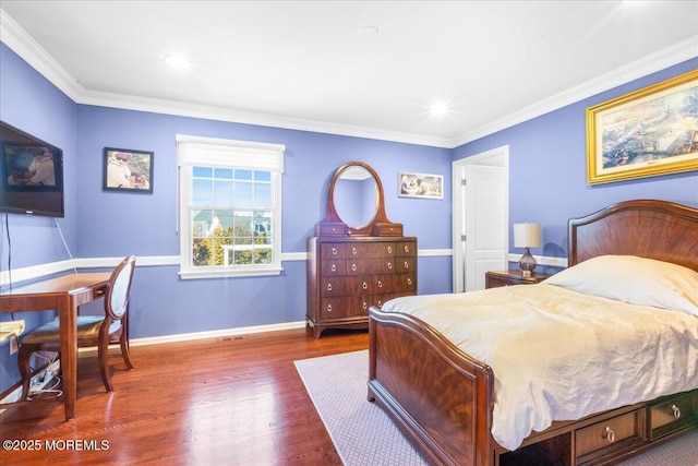 bedroom with crown molding and dark hardwood / wood-style floors