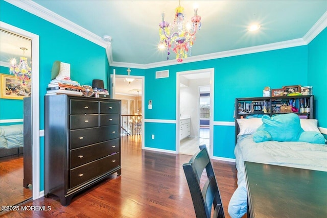 bedroom with a notable chandelier, crown molding, dark wood-type flooring, and ensuite bath