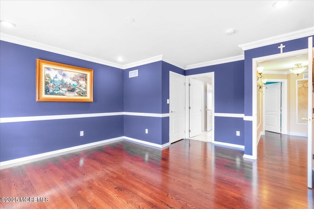 empty room featuring hardwood / wood-style flooring and crown molding