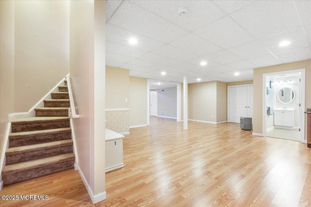 entryway featuring a paneled ceiling and light wood-type flooring