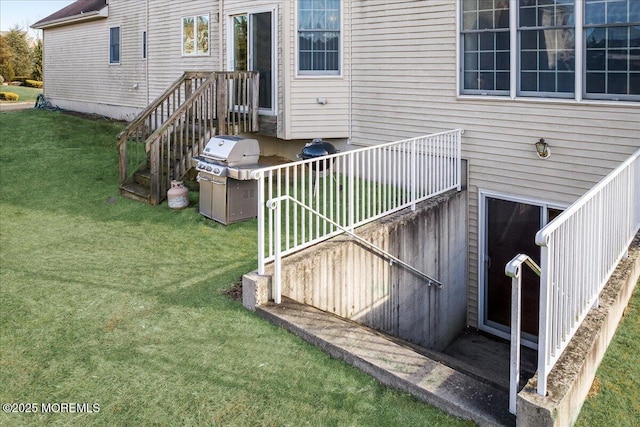 deck featuring area for grilling and a lawn